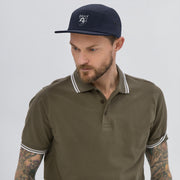 Stylish man wearing a Five Panel Cap with a polo shirt, showcasing streetwear fashion and everyday comfort.