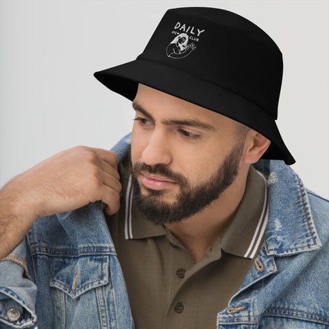 Man wearing a stylish black bucket hat with daily club logo, paired with a denim jacket.