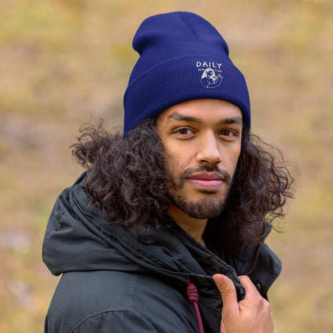Man wearing a navy cuffed beanie, showcasing warmth and style, perfect for cold weather and outdoor activities.