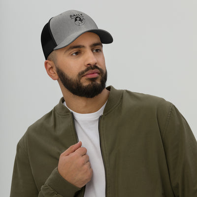 Man wearing a stylish trucker cap with mesh back, showcasing comfort and classic streetwear vibes.
