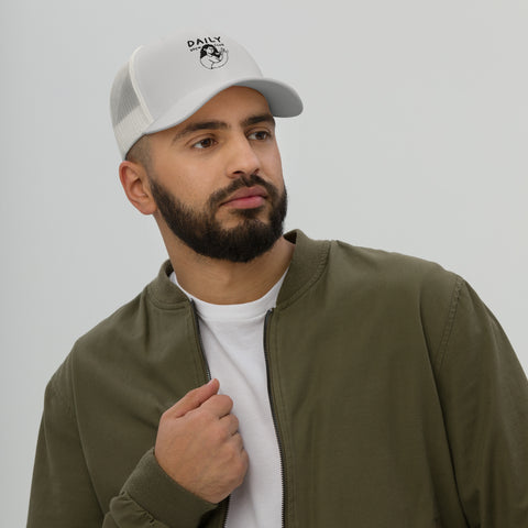 Man wearing a stylish classic trucker cap with mesh back, showcasing casual streetwear for comfort and coolness.